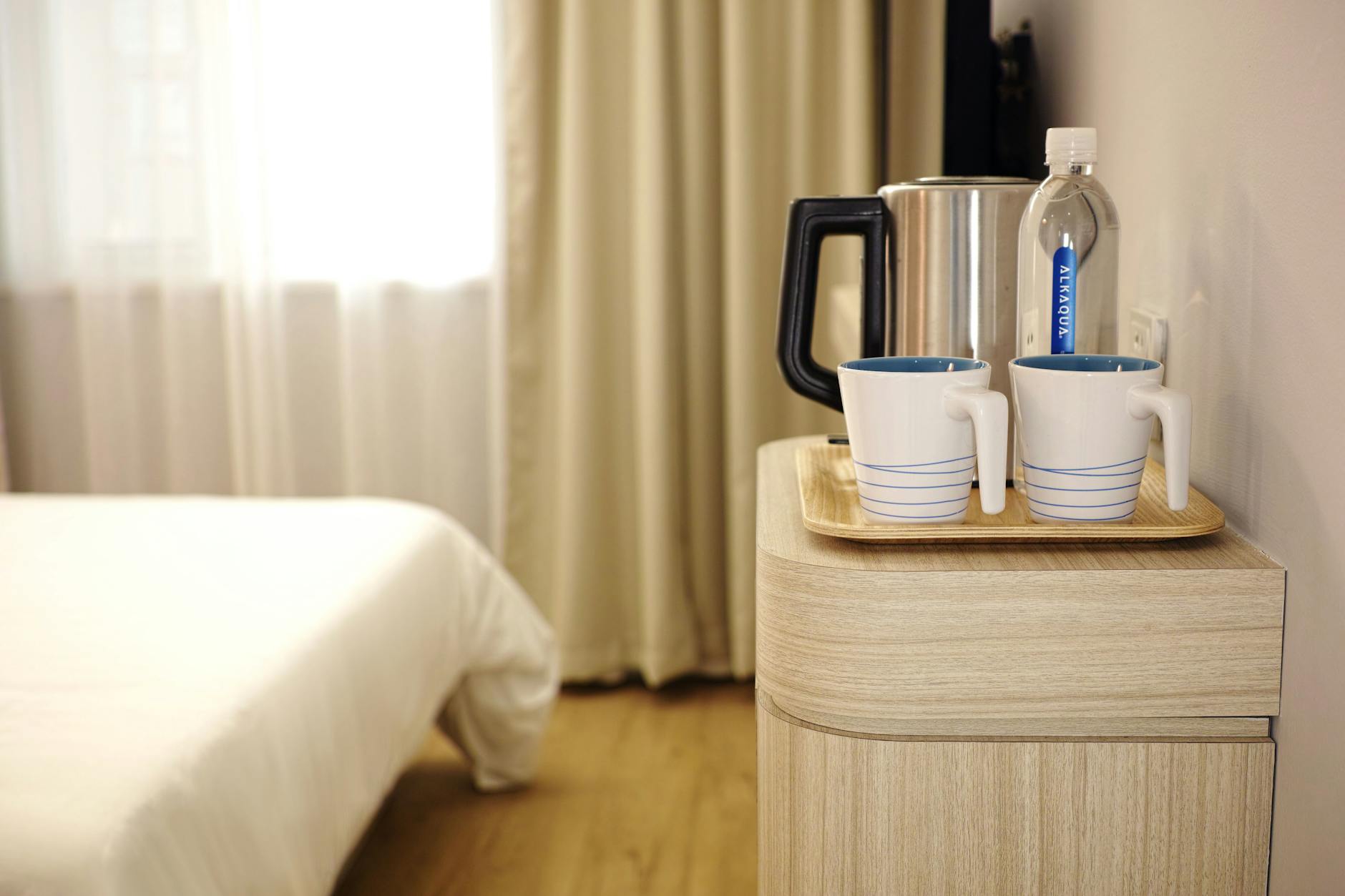 two white ceramic mug on brown wooden tray